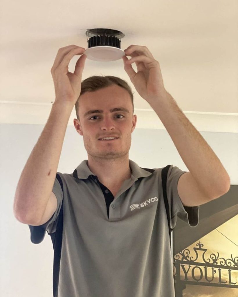Employee working at ceiling light installation